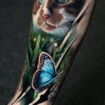 A reddish cat with butterfly