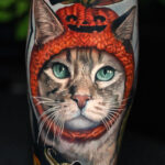 a cat with a pumpkin hat and bunny